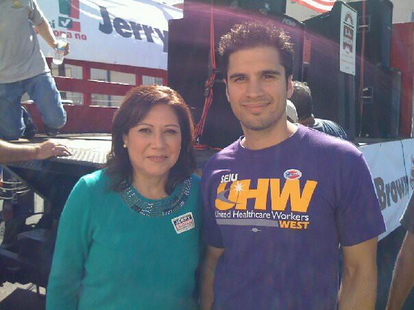 Zoltan Csaplar and Hilda Solis standing in front of a truck being loaded.