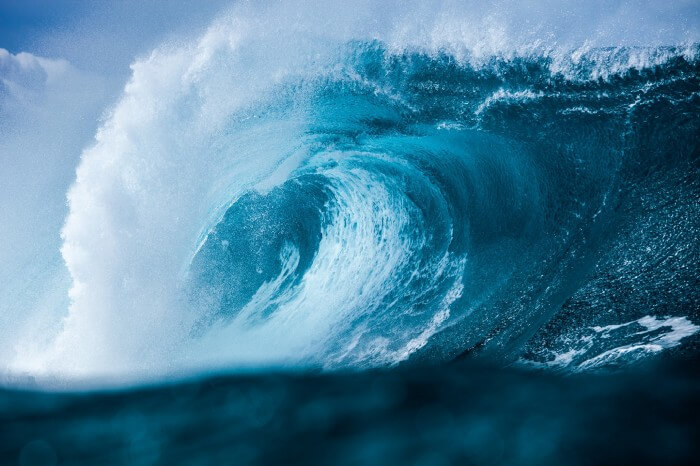 A large deep blue wave curling and crashing.